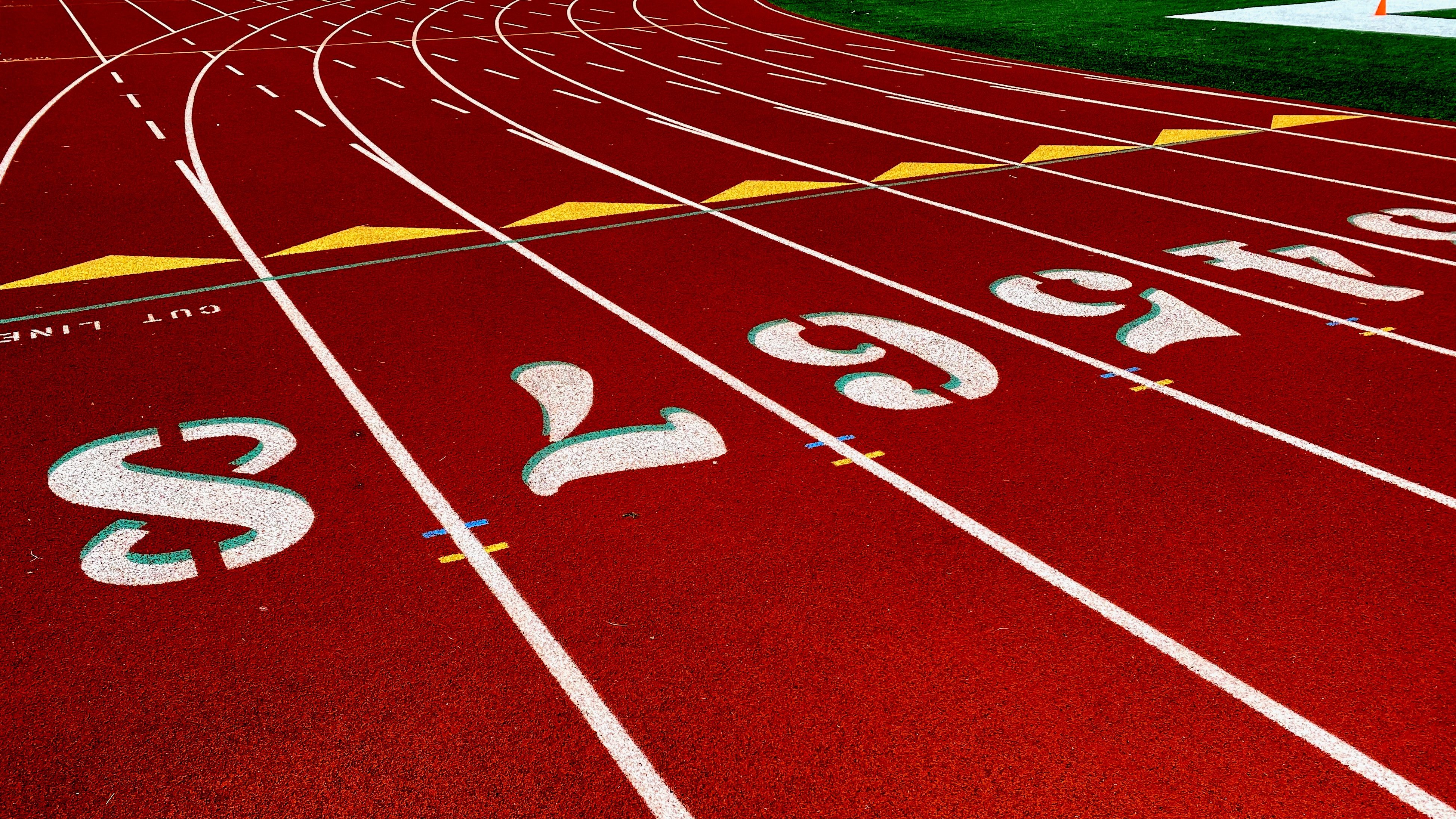 A race track for running, with lanes numbered 1-8 at the start line.