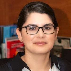 Headshot of Erika Romero of Ever Educating wearing glasses and smiling